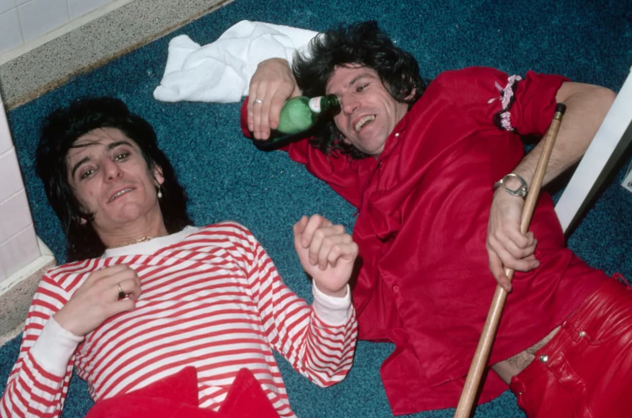 Keith Richards and Ron Wood lie on the floor of a New Barbarians concert, May 1979.